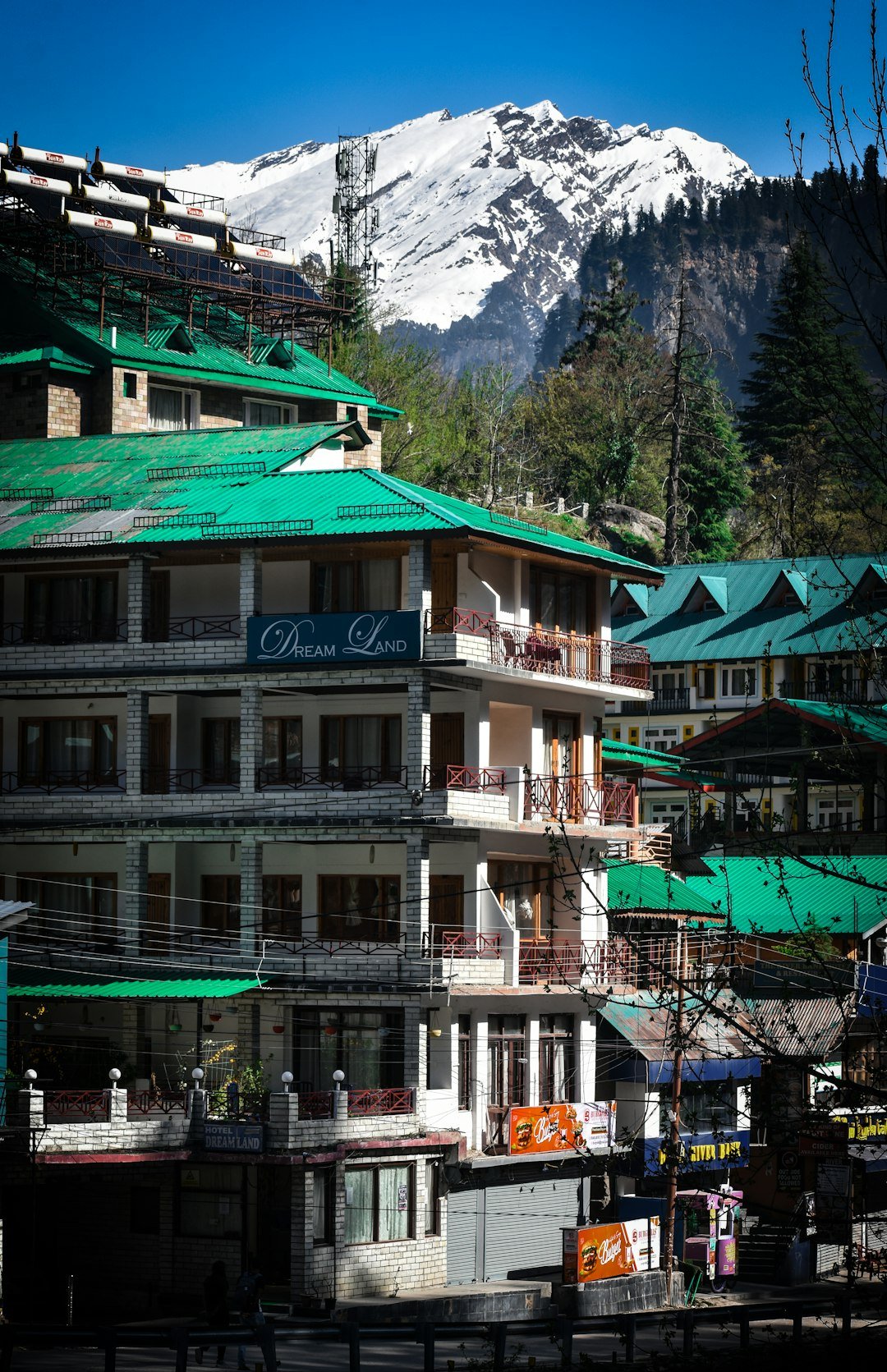 A group of buildings with a mountain in the background
