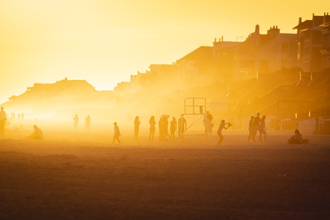 a group of people standing on a beach