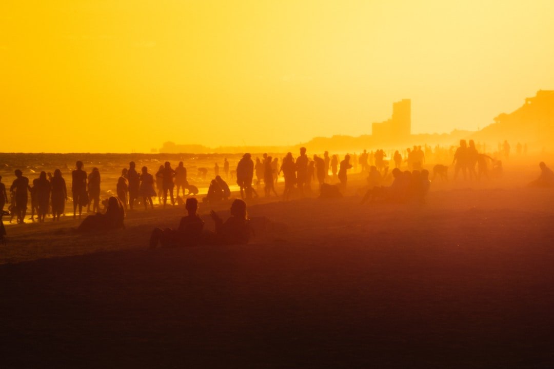 a group of people standing on a hill with a city in the background