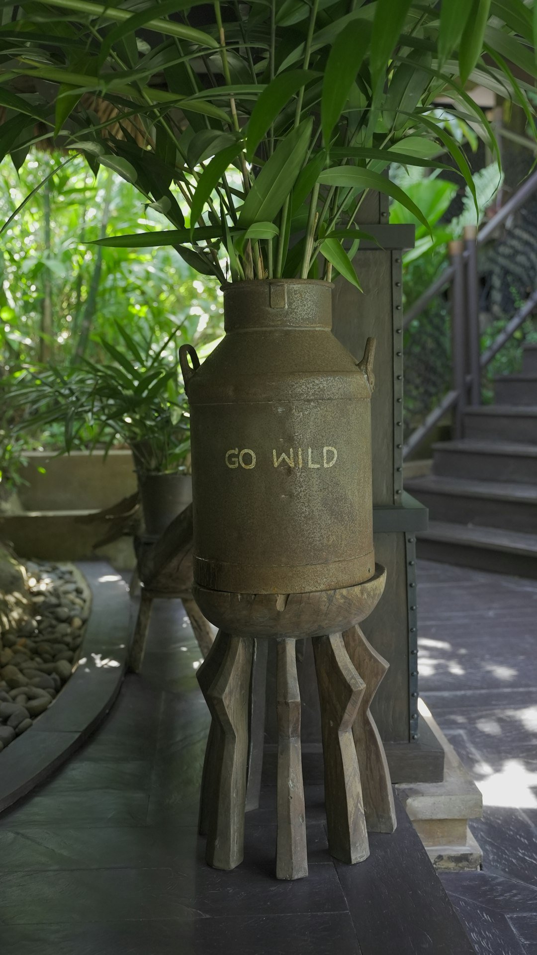 a potted plant sitting on top of a wooden stand
