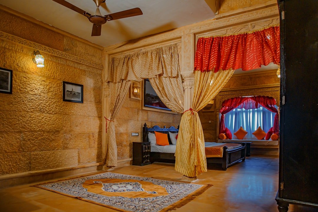 a bedroom with a bed and a fan