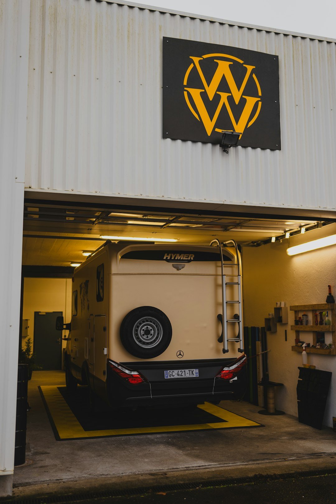 A large white truck parked inside of a garage