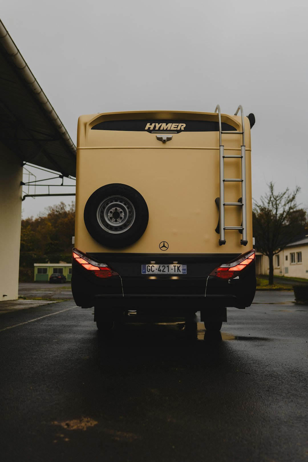 A yellow truck parked in a parking lot