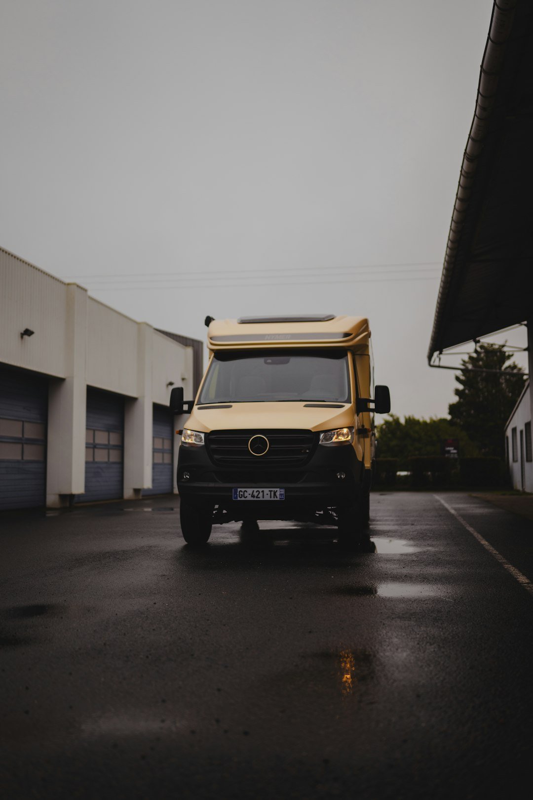 A truck parked in a parking lot next to a building