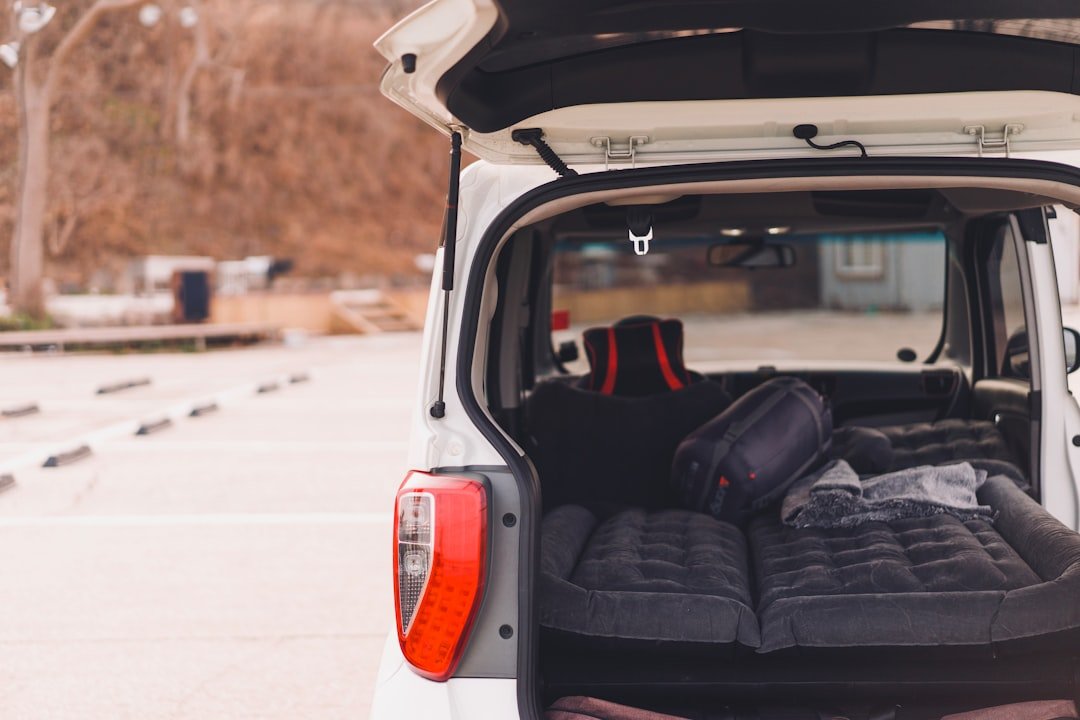 the back of a white van with luggage in the back