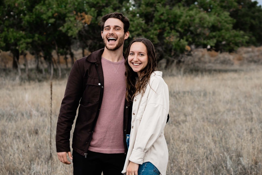A man and a woman standing in a field