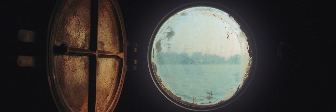 a round window with a view of a body of water