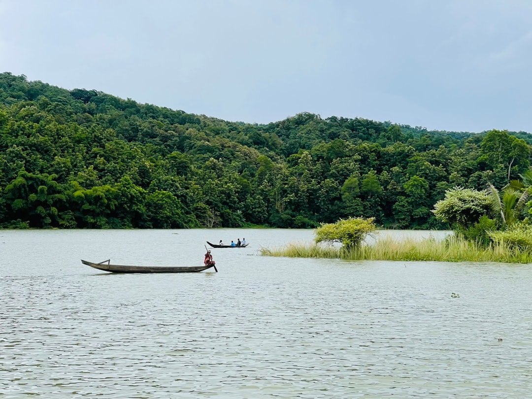 two people in a boat on a large body of water