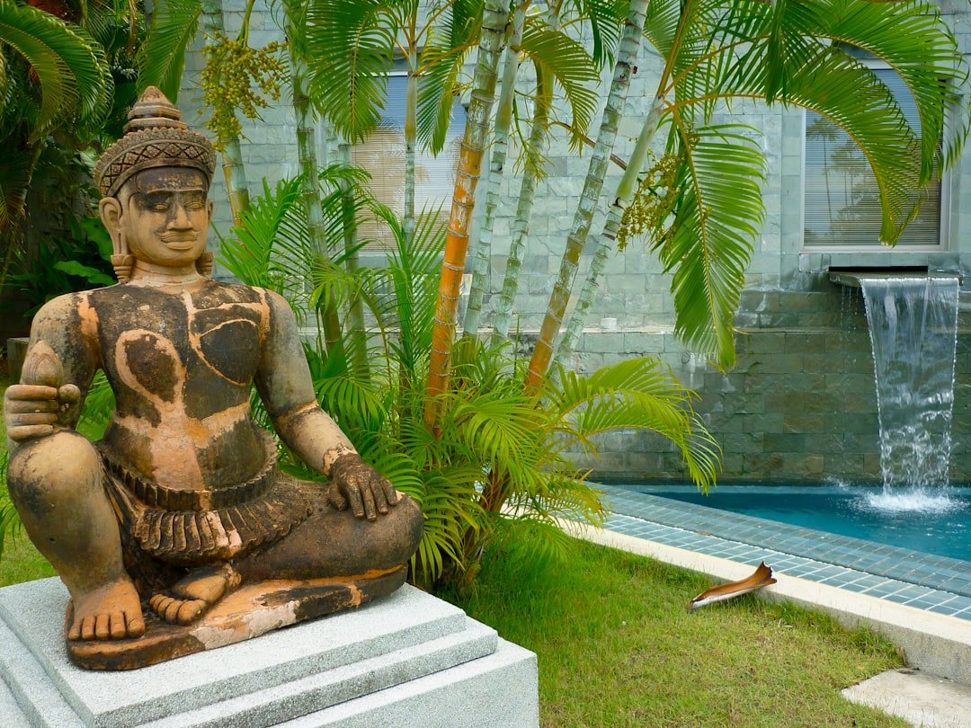 a statue of a person by a pool