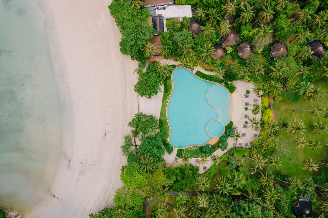 A bird's eye view of a beach with a pool