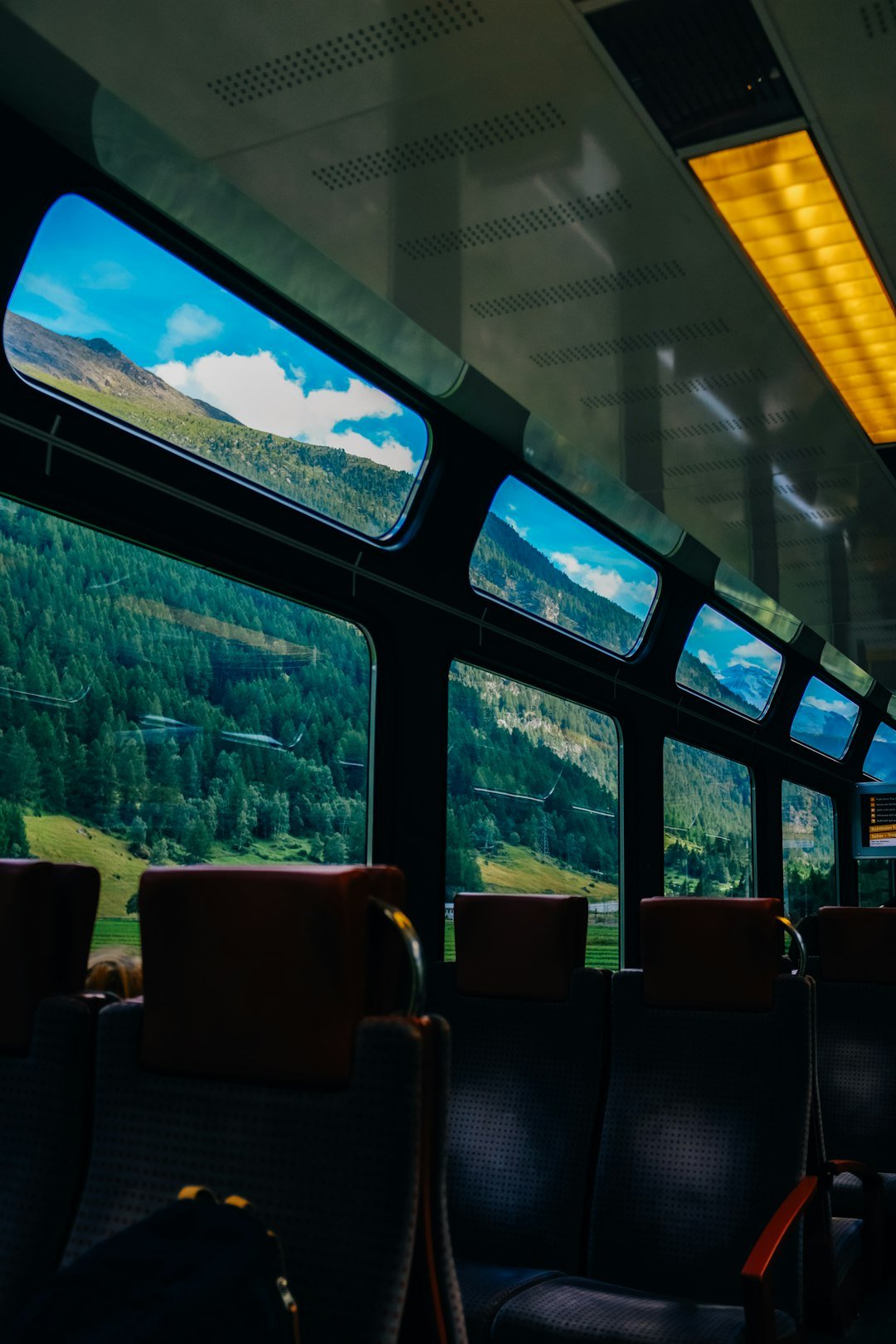 a view of a mountain from inside a train