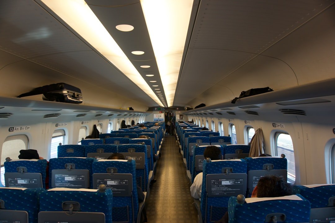 the inside of an airplane with blue seats