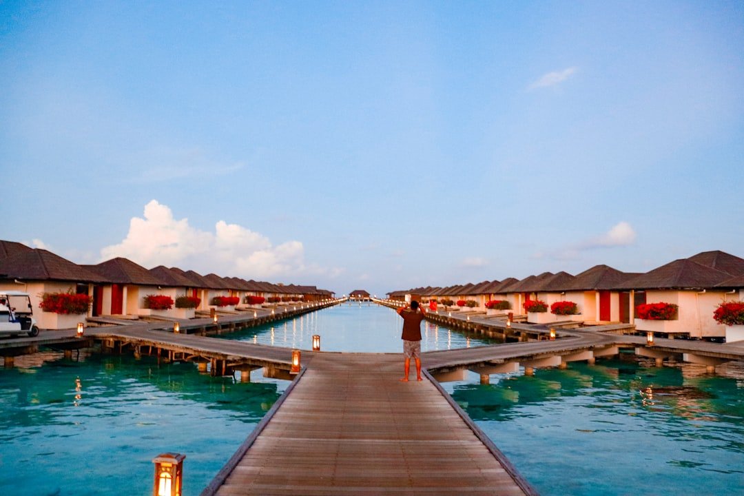 Overwater bungalows line a beautiful, turquoise sea.