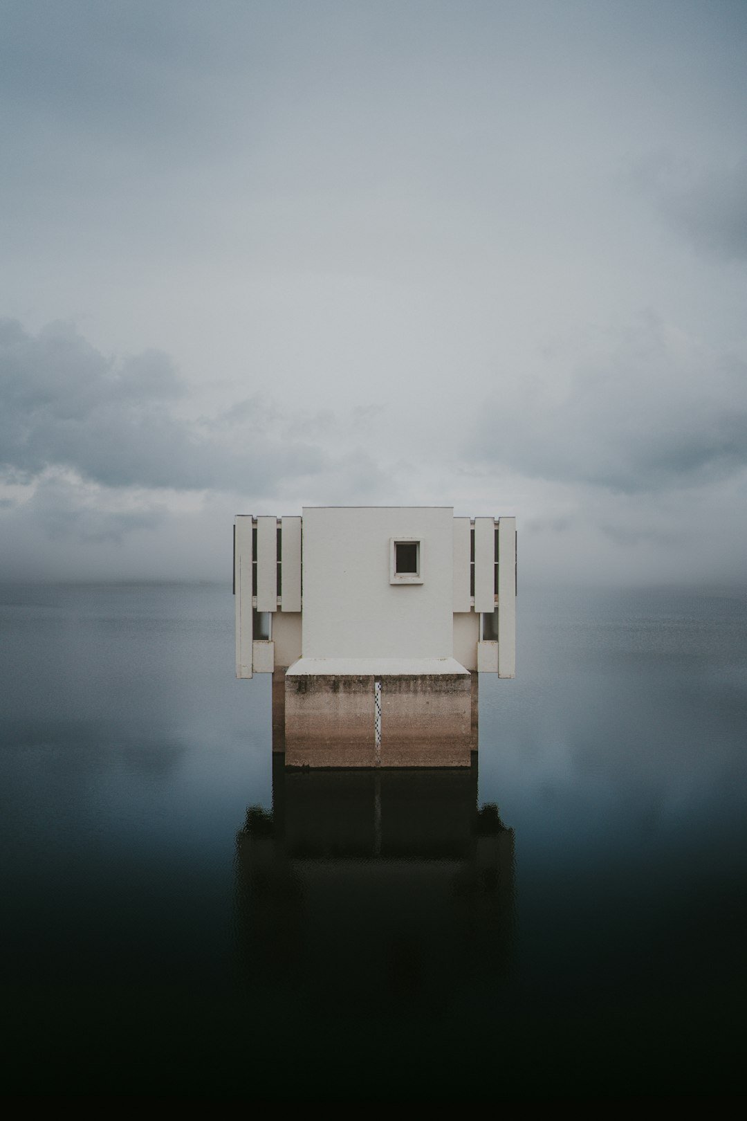 A white building sitting on top of a body of water