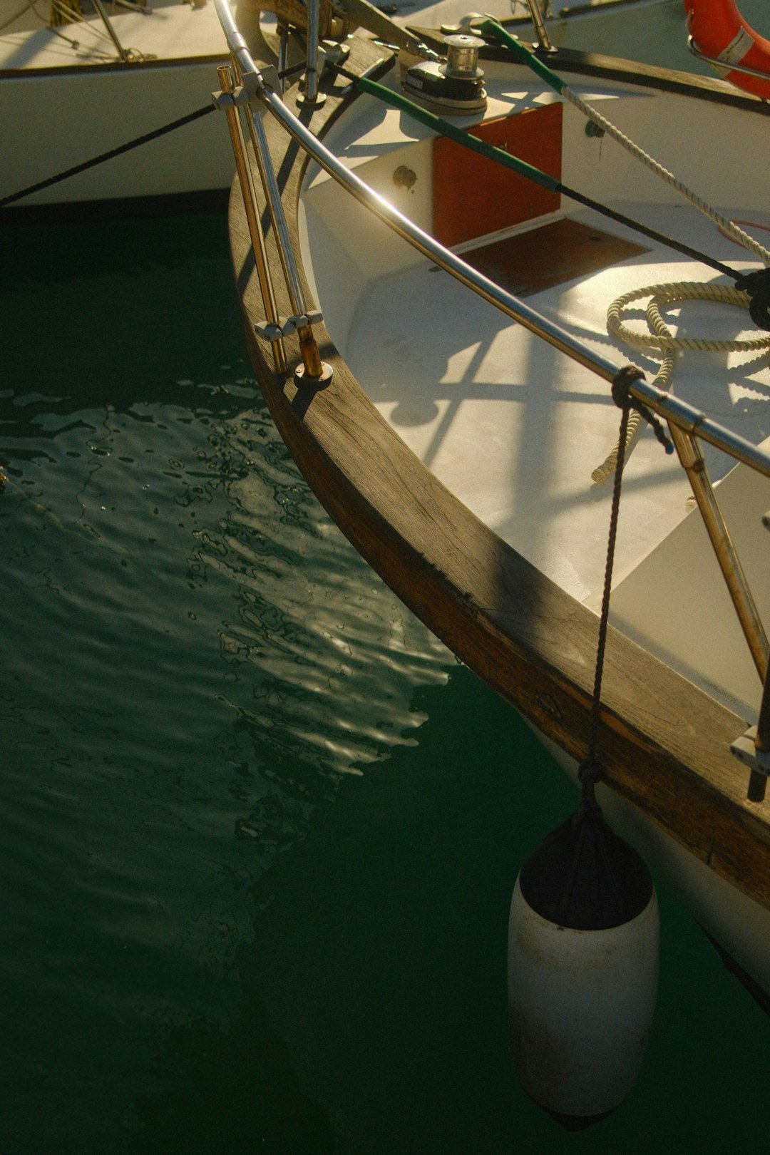 A sailboat docked at a dock in the water