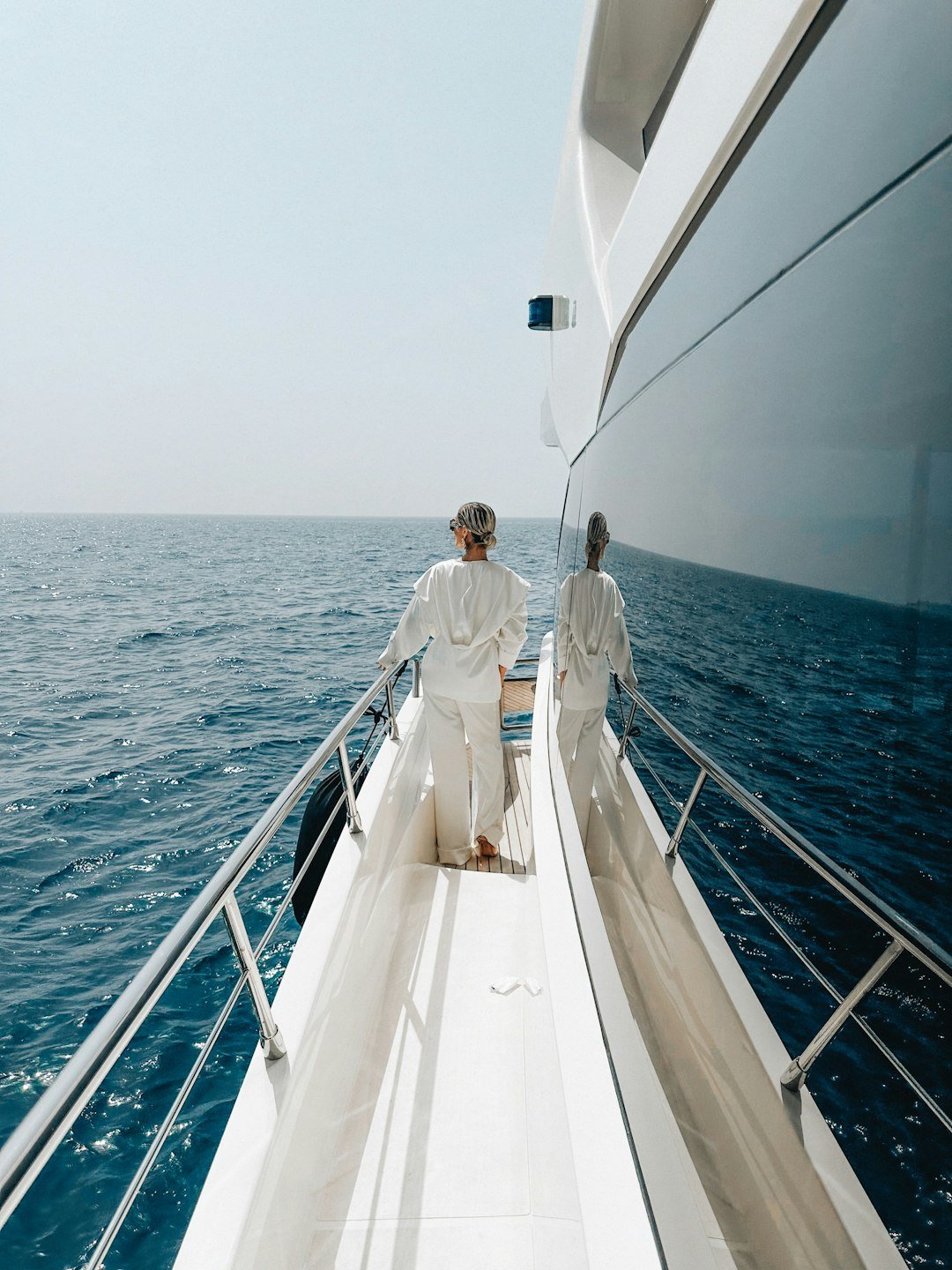 Two people standing on the deck of a boat