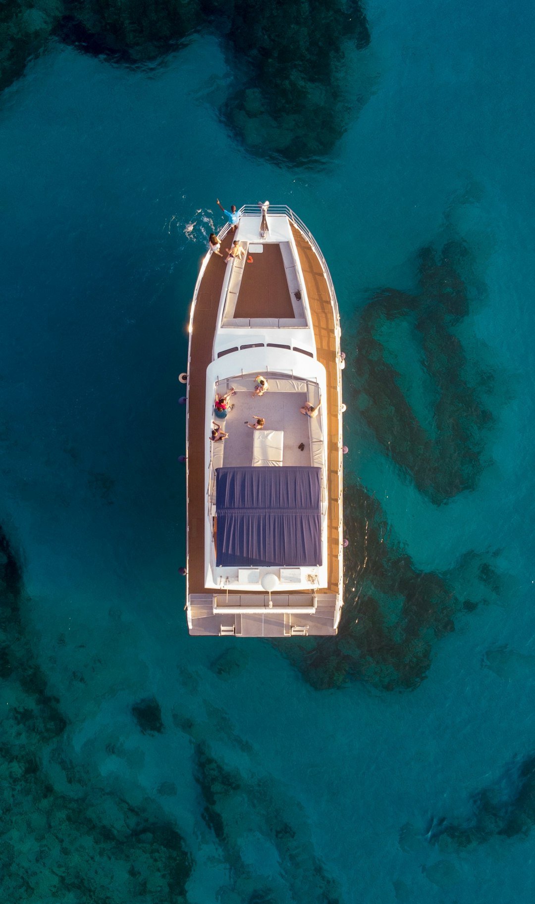 aerial photography of white and brown boat on water