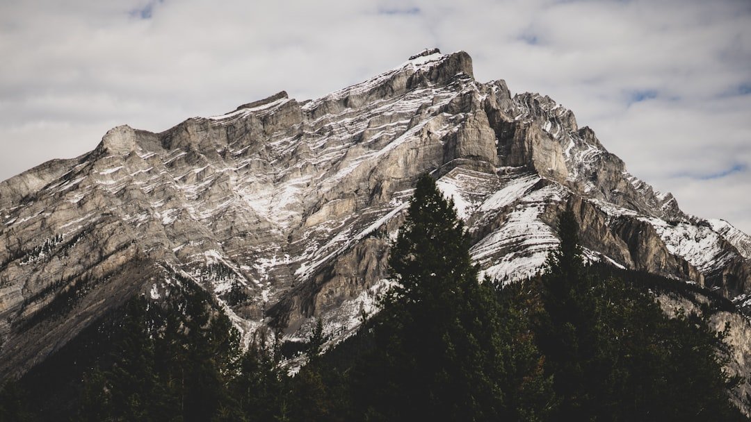 gray rocky mountain under white clouds during daytime