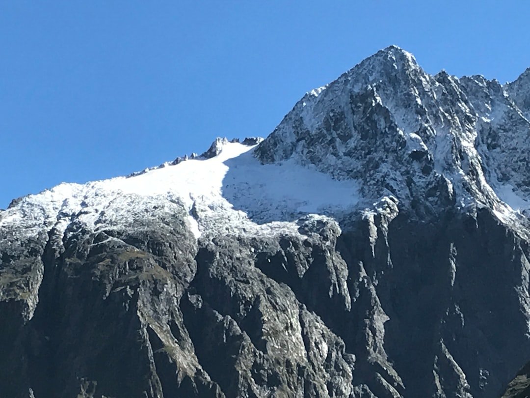 a snow covered mountain with a clear blue sky