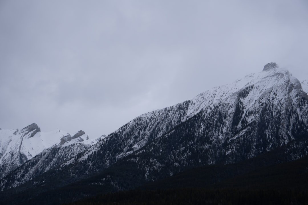 a mountain covered in snow on a cloudy day