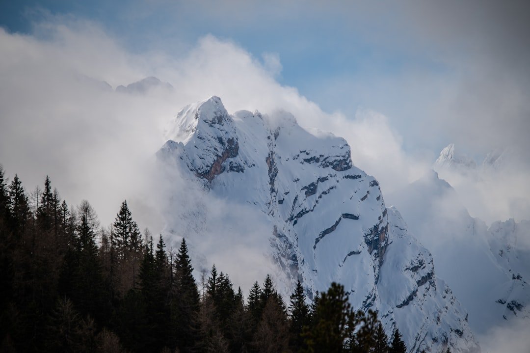 Snowy mountain peaks emerge from the clouds.