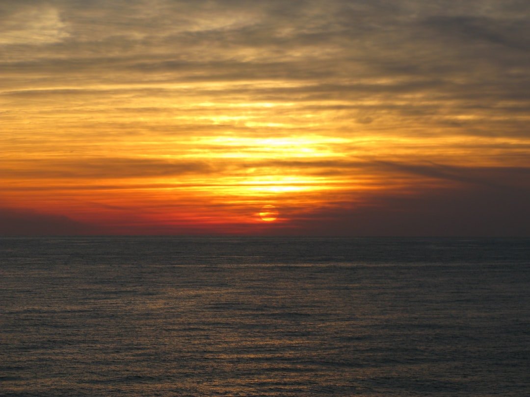 body of water during sunset
