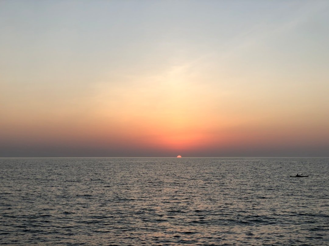 body of water during sunset