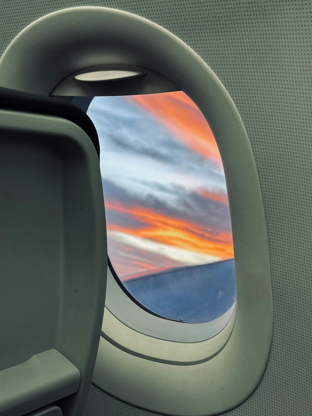 an airplane window with a view of the sky