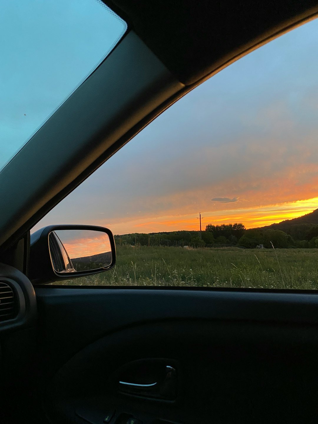 A view of a sunset from inside a car