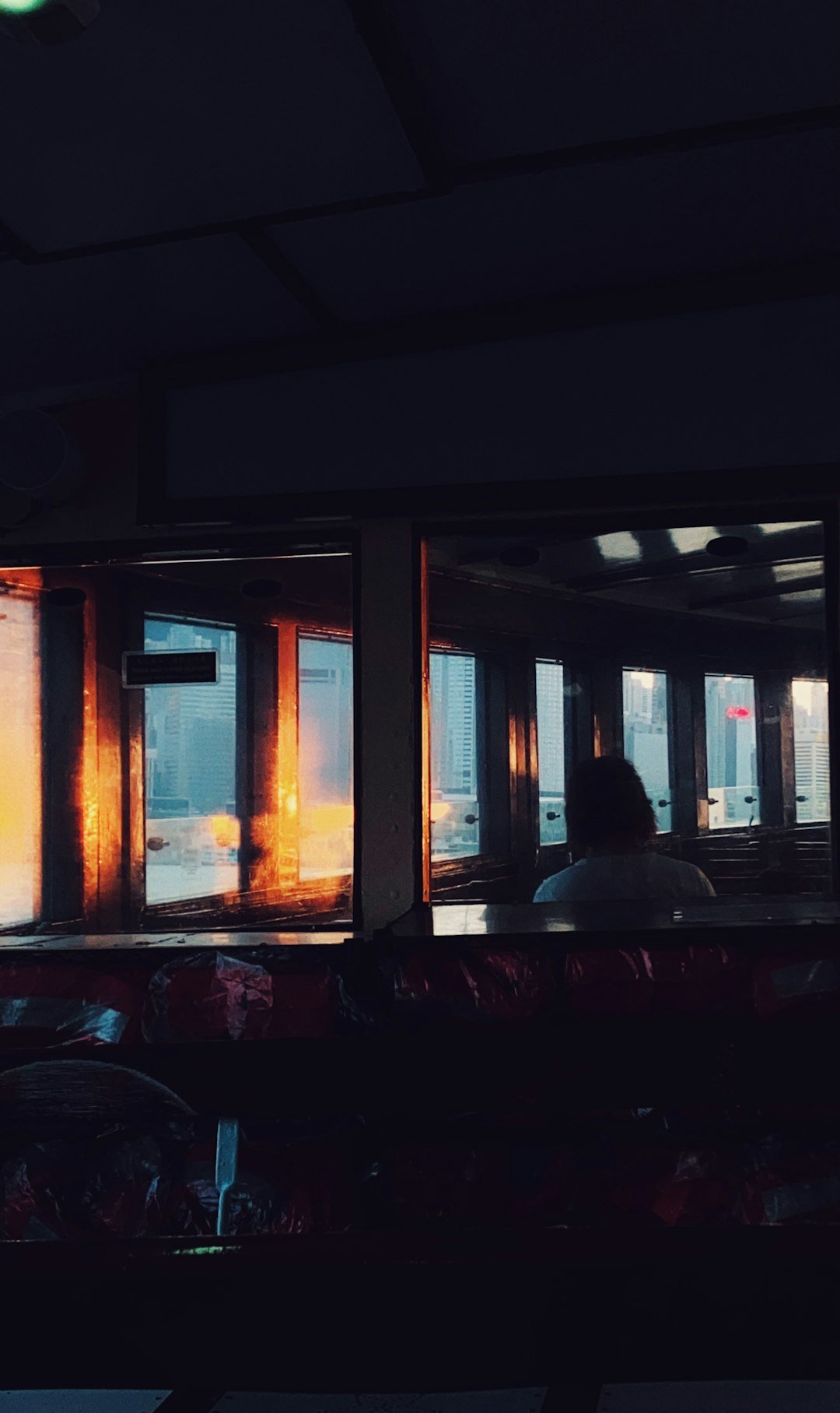 person in black jacket standing near window during daytime