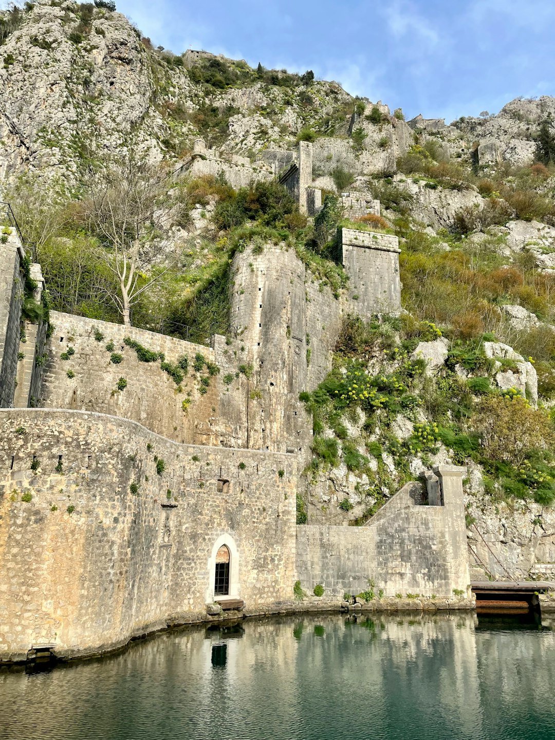 an old stone castle on a cliff overlooking a body of water