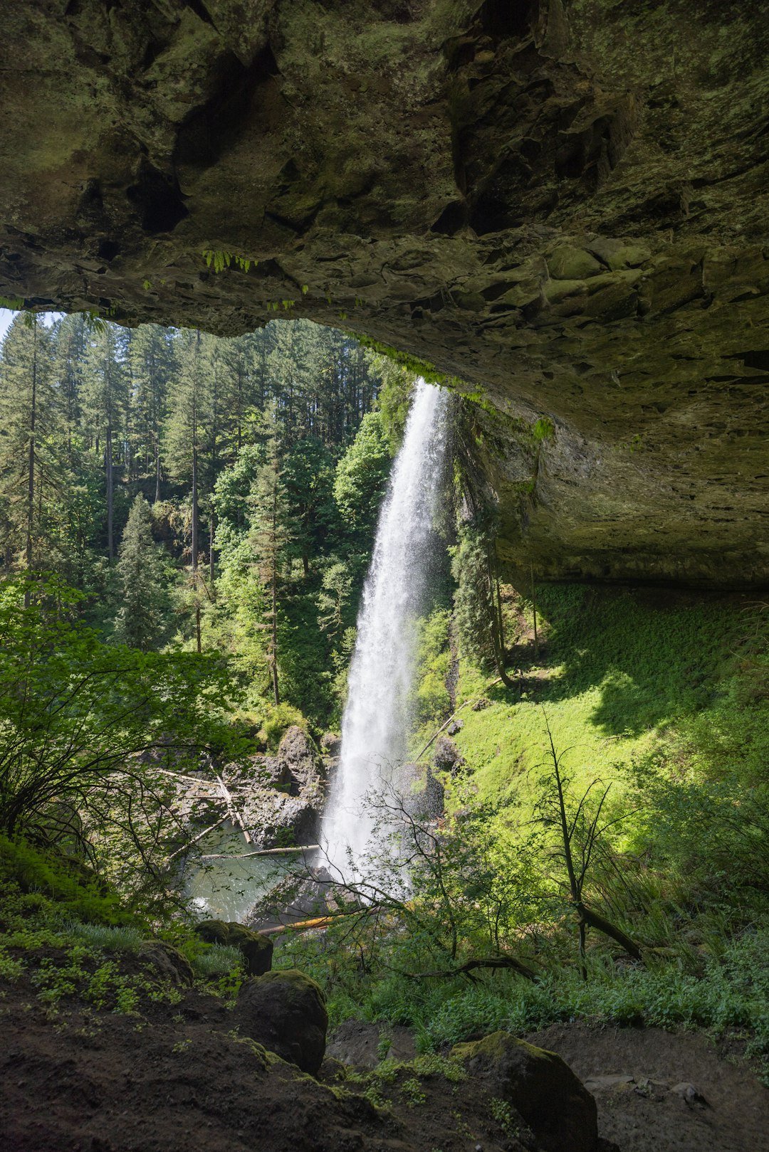 a large waterfall is coming out of a cave