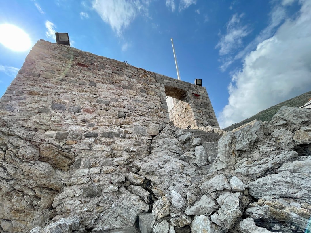 a stone tower with a flag on top of it