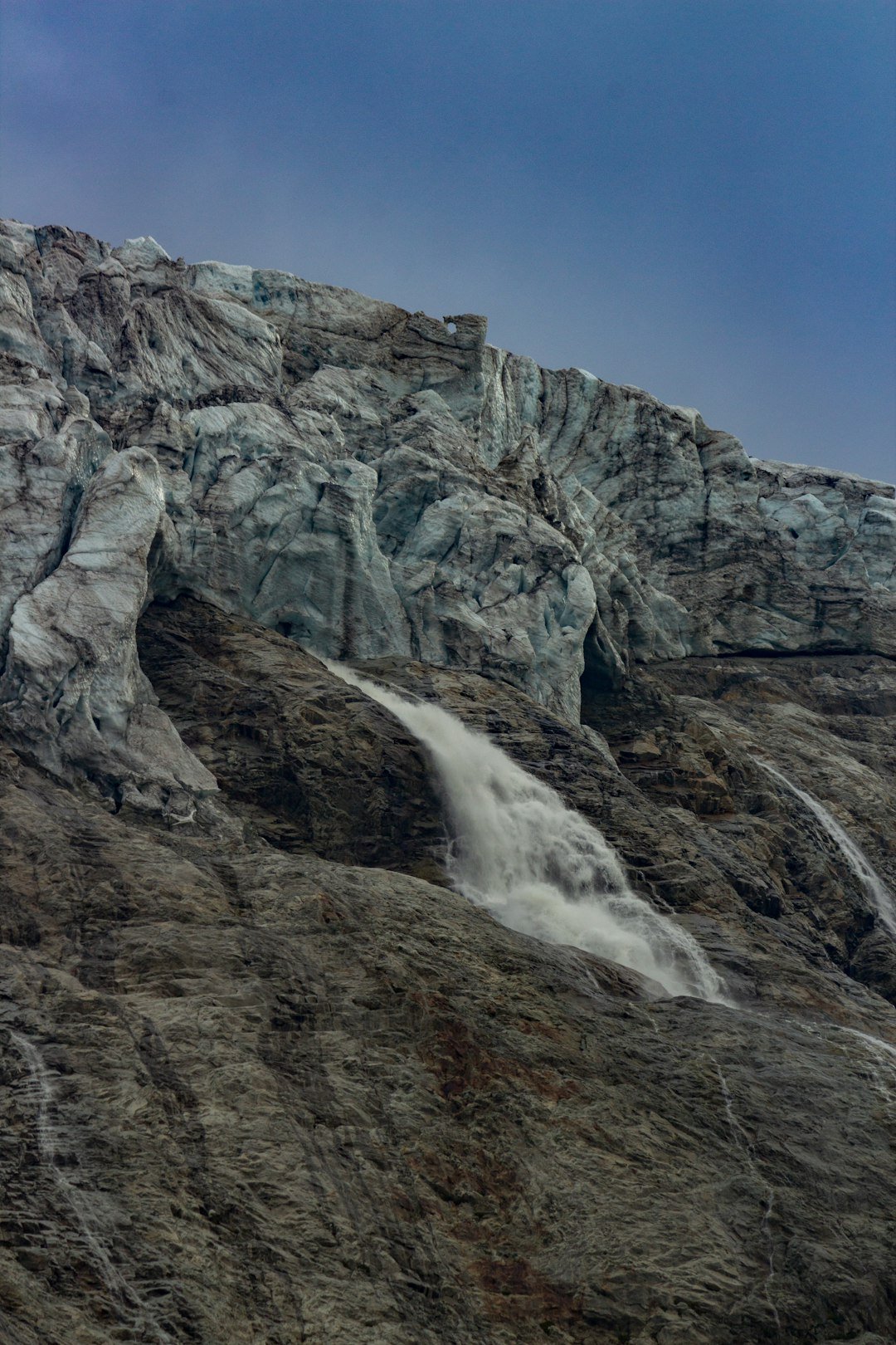 a mountain with a waterfall coming out of it