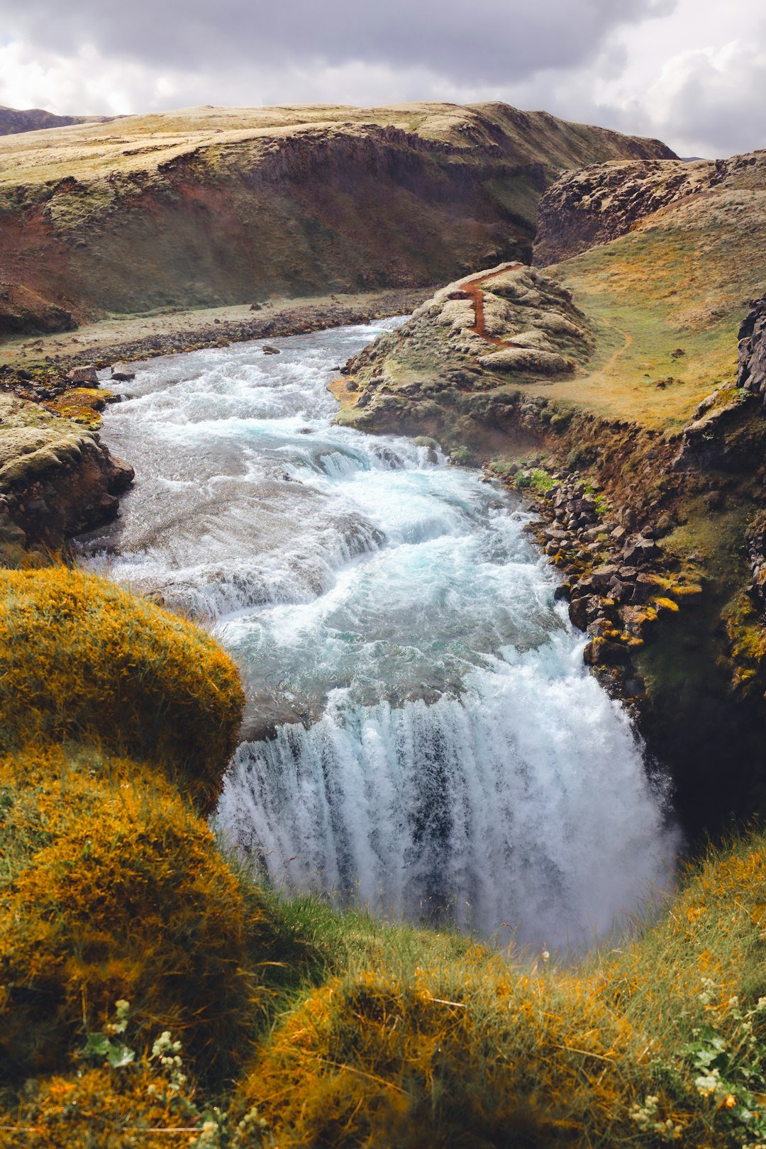 a man standing on the edge of a waterfall