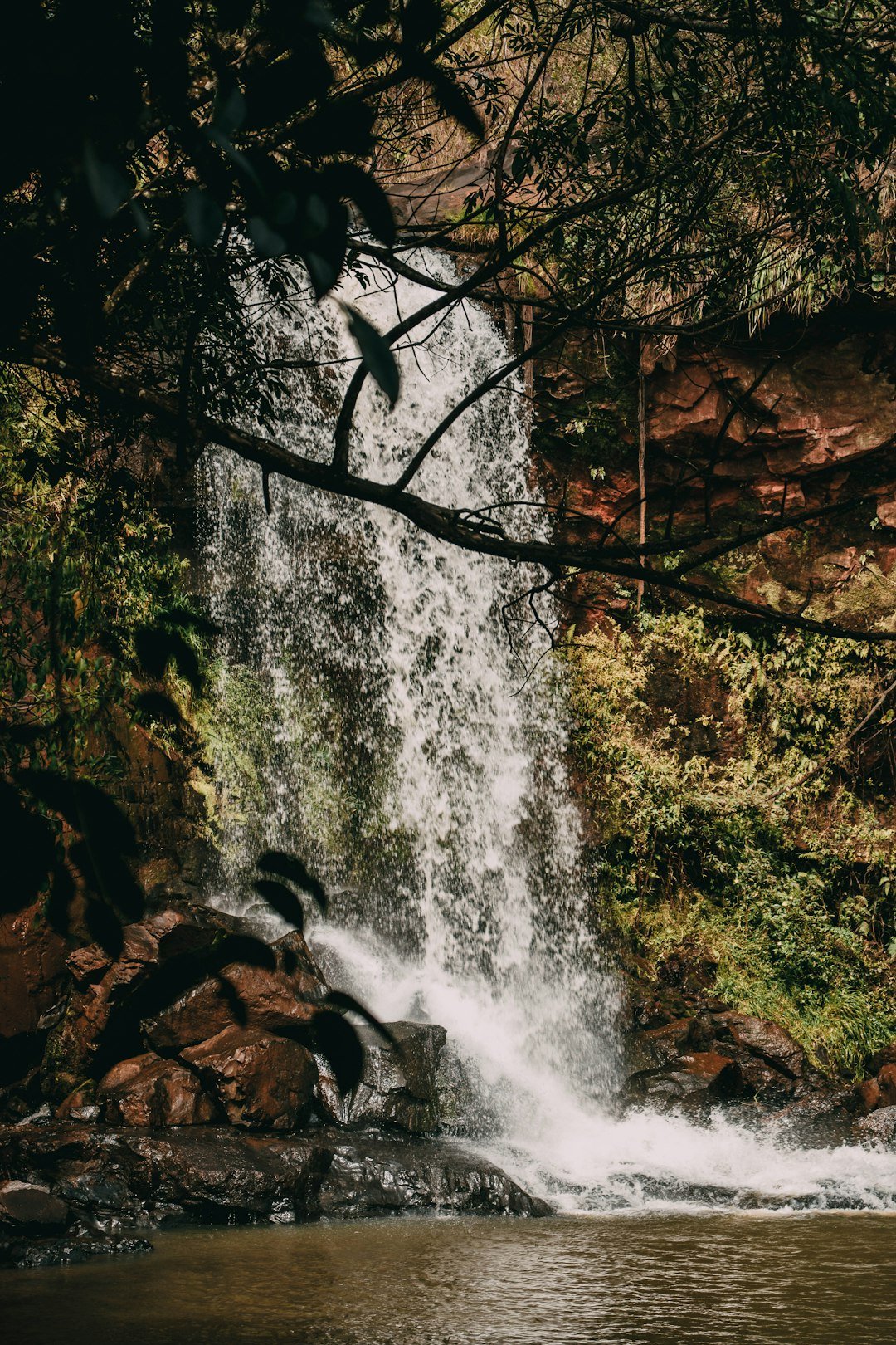 water falls on brown rocky mountain