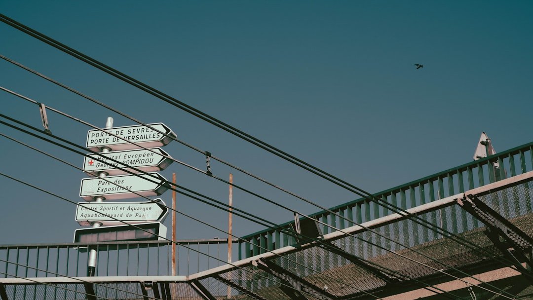 a street sign sitting on the side of a bridge
